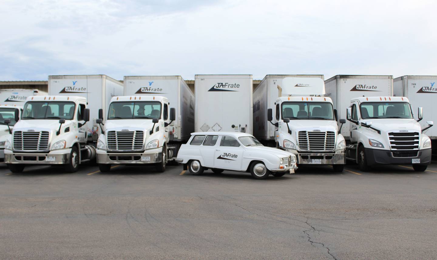 Richard "Douglas" Jennings' 1967 Saab Station Wagon that he started JA Frate with in 1971 lined up with the current fleet of trailers.