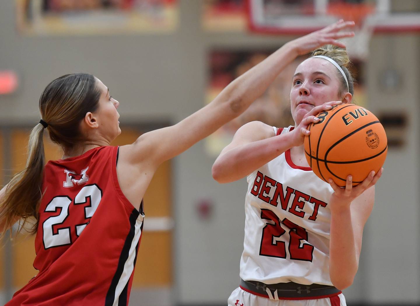 Benet’s Bridget Rifenburg starts to shoot as Marist’s Olivia Barsch (23) reaches in to foul her during a game on January 8, 2025 at Benet Academy in Lisle.