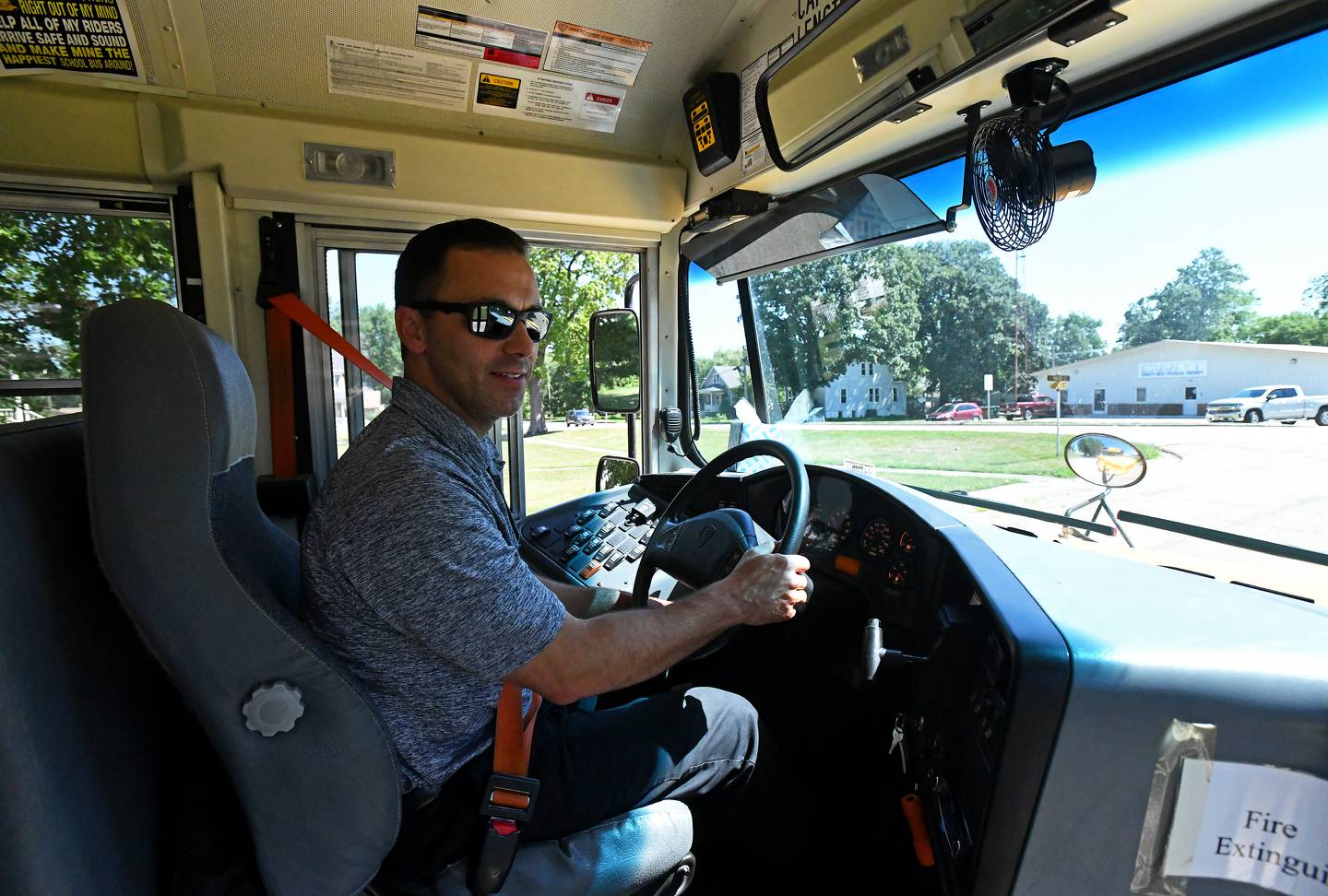 Herscher High School principal Brad Elliot drives a school bus around campus on July 20, 2022, something he did frequently last school year to help cover bus routes as driver shortages hit the district. Elliot said the possibility of seeing a nationally-ranked track athlete, 2021 grad Drew Rogers, unable to attend competitions is what ultimately drove him to find a solution. Elliot would drive over 100 routes last school year.
