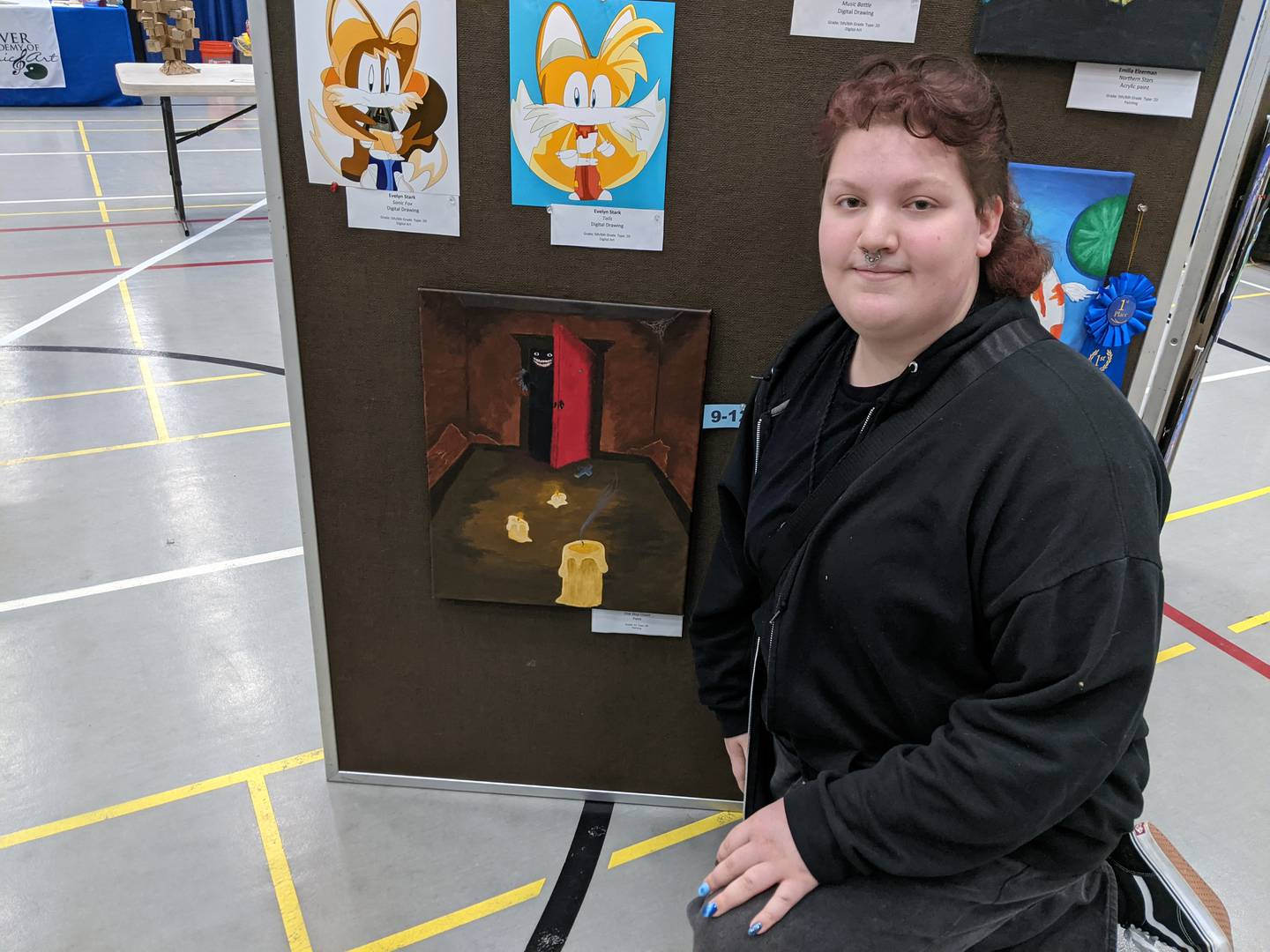 Plano High School junior Zack Stover shows off his painting, called “One Step Closer," at the Oswego Hometown Expo Feb. 22 at Oswego High School. The painting was part of an art show at the expo.