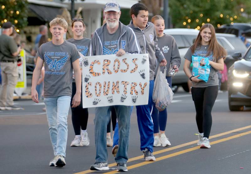 The Princeton High School cross country team walks during the Homecoming parade on Thursday, Oct. 3, 2024 downtown Princeton.