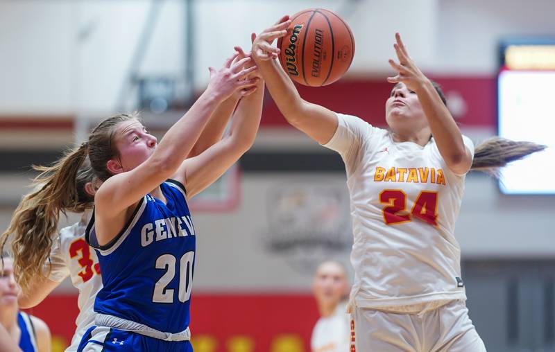 Geneva’s Caroline Madden (20) and Batavia’s Hallie Crane (24) fight for a rebound during a basketball game at Batavia High School on Friday, Jan 26, 2024.