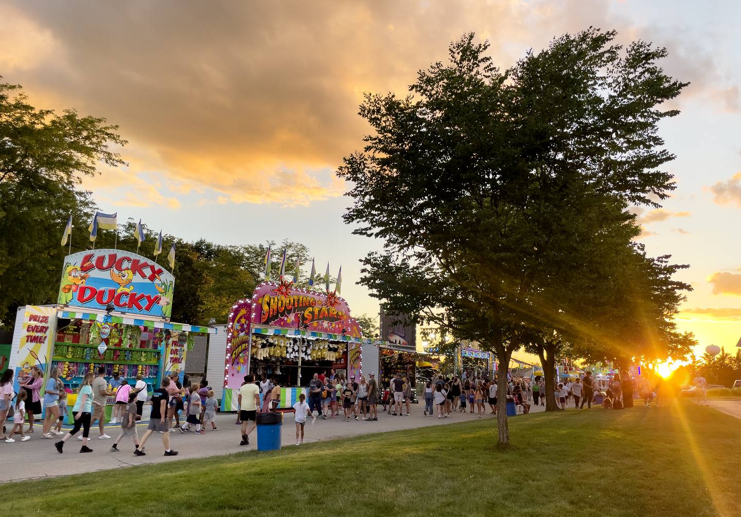 The sun sets as attendees walk the carnival last year during the first day of the 2024 Bourbonnais Friendship Festival.