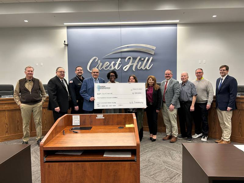 Representative Lauren Underwood presents a $200,000 grant check to Crest Hill officials at the Crest Hill City Hall on Jan. 29.