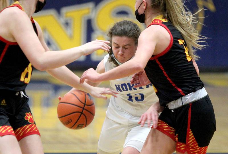 Wheaton North's Claire Hyde tries to get through a pair of defenders during a home game against Batavia on Thursday, Jan. 20, 2022.