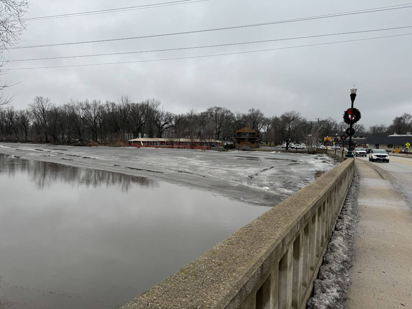 Cars travel along Illinois Route 53 in Wilmington as the road was opened up again Friday, Jan. 26 following flooding along the Kankakee River.