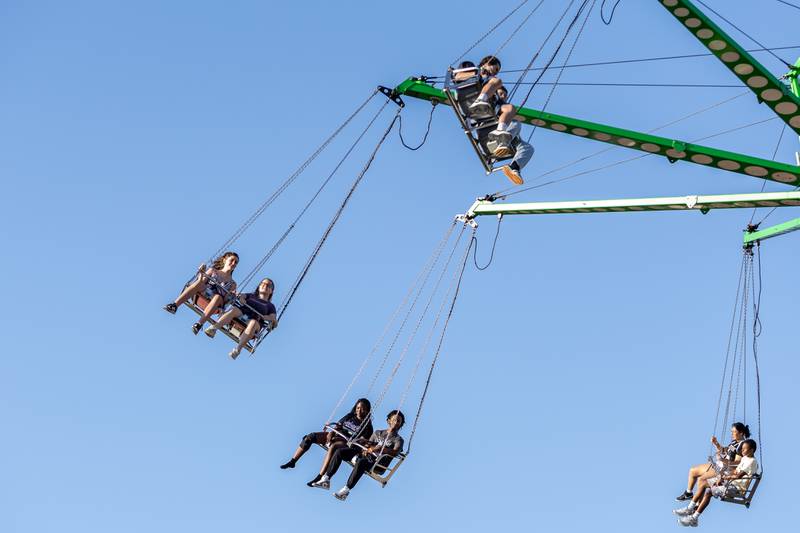 Taste of Joliet attendees ride the giant swing at Busey Bank Field at Joliet Memorial Stadium on June 20, 2025.