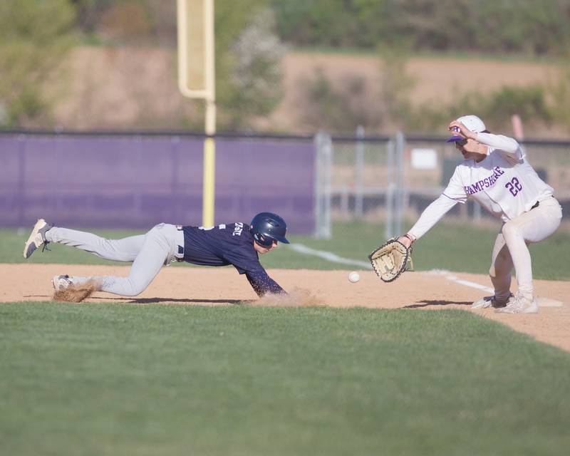 Cary Grove's Cooper Motz slides into first base before the tag by Hampshire's Anthony Karbowski on Wednesday, April24,2024 in Hampshire.