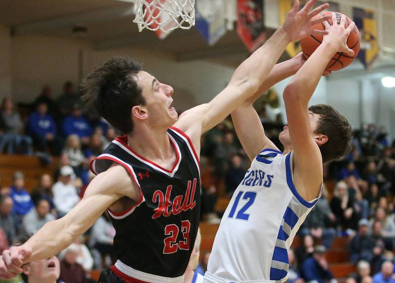 Princeton's Tyson Phillips eyes the hoop as Hall's Braden Curran defends on Friday, Jan. 26, 2024 at Princeton High School.