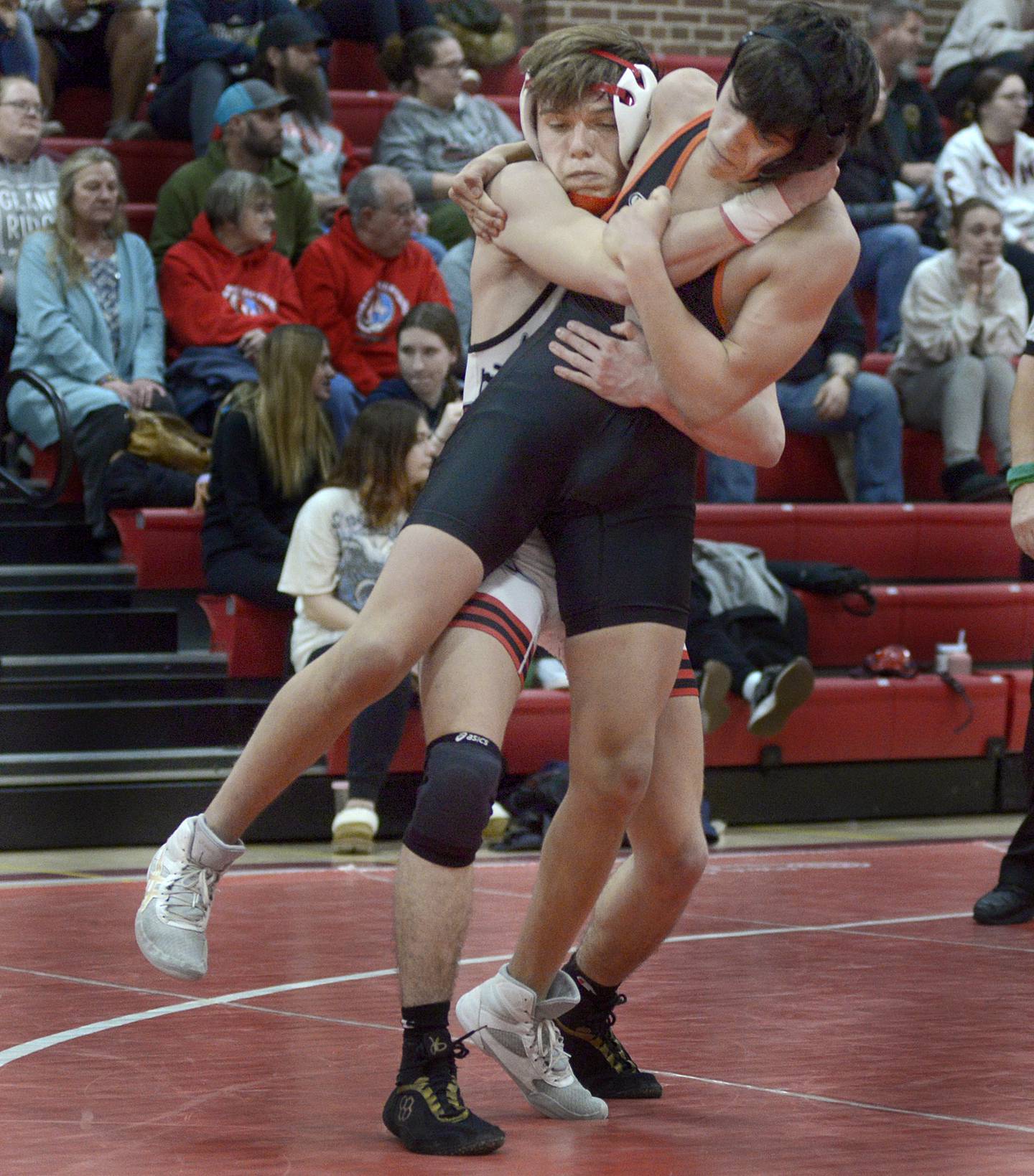 Ottawa’s Wyatt Wheeler works to bring down Kaneland’s John Havroh in the 132 match Thursday at Ottawa.