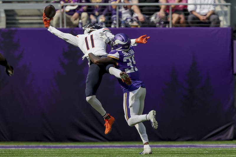 Chicago Bears wide receiver Darnell Mooney (11) catches the ball with one hand against Minnesota Vikings cornerback Chandon Sullivan (39) during the first half of an NFL football game Sunday, Oct. 9, 2022 in Minneapolis. (AP Photo/Stacy Bengs)