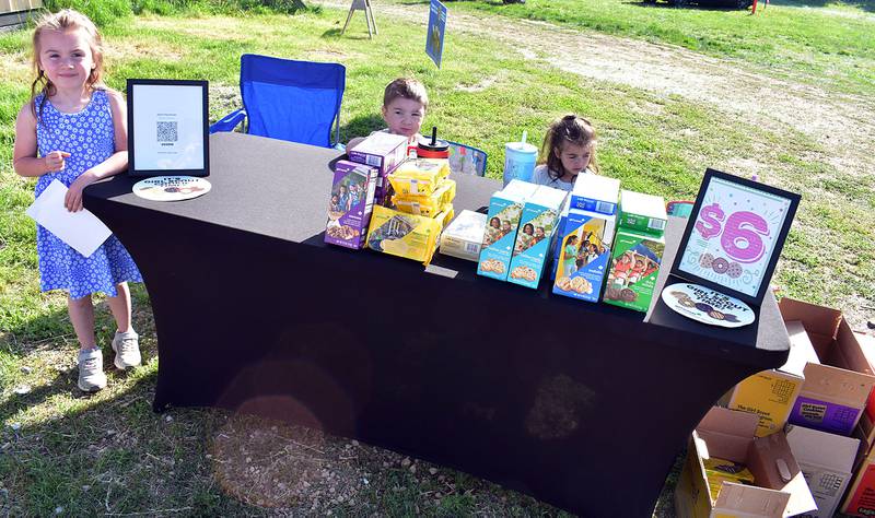 Lillie (left), 5, Maverick, 3, and Aubrie, 5 of Girl Scout troop 735 sells cookies Saturday, May 10, 2025, at P&C Little Rascals’ open house.