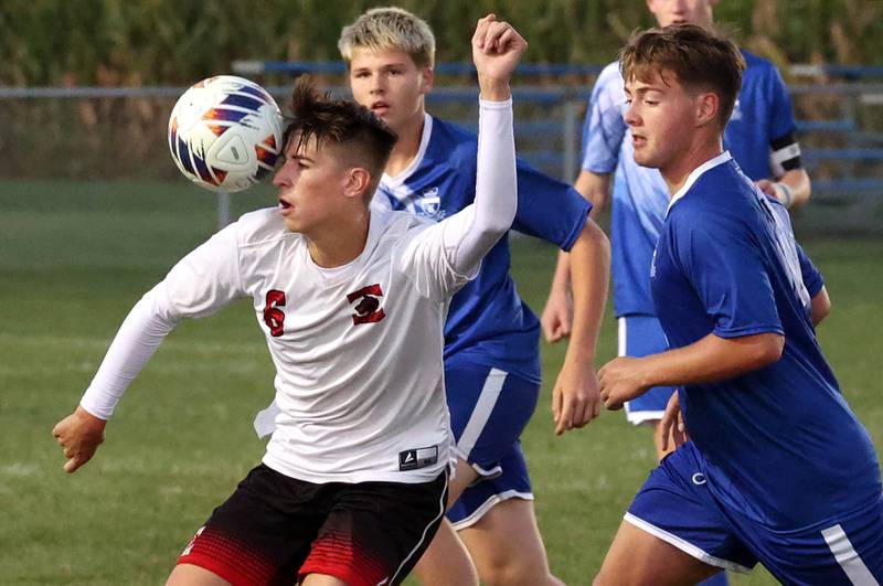 Indian Creek's Jason Brewer heads the ball between Hinckley-Big Rock's Judah Miceli (left) and Austin Roop during their game Wednesday, Oct. 2, 2024, at Hinckley-Big Rock High School.
