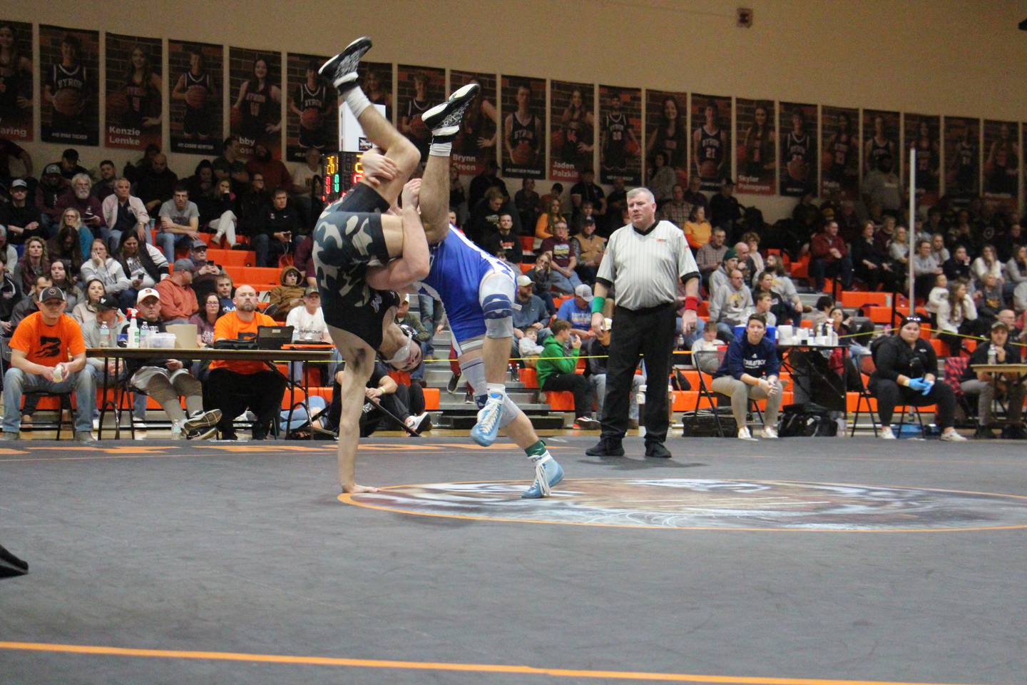 Newman's Brady Grennan executes a takedown of Marian Central's Vance Williams in the 132-pound first-place match Saturday, Feb. 10, 2024, at the Class 1A Byron Sectional at Byron High School.