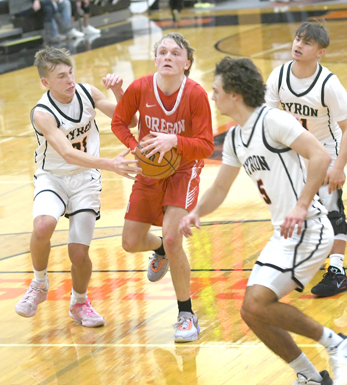 Oregon's Jordan Croegaert drives to the basket as Byron's Cason Newton (21) gets a hand on the ball during a Jan. 20 game in Byron.