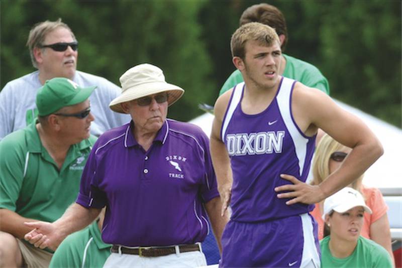 Rich Lawton, Dixon’s throws coach, talks with Jon Shippert during the discus on Thursday at the Class 2A state preliminaries in Charleston. Lawton, who has coached at Dixon since 1978, is retiring after the state meet.