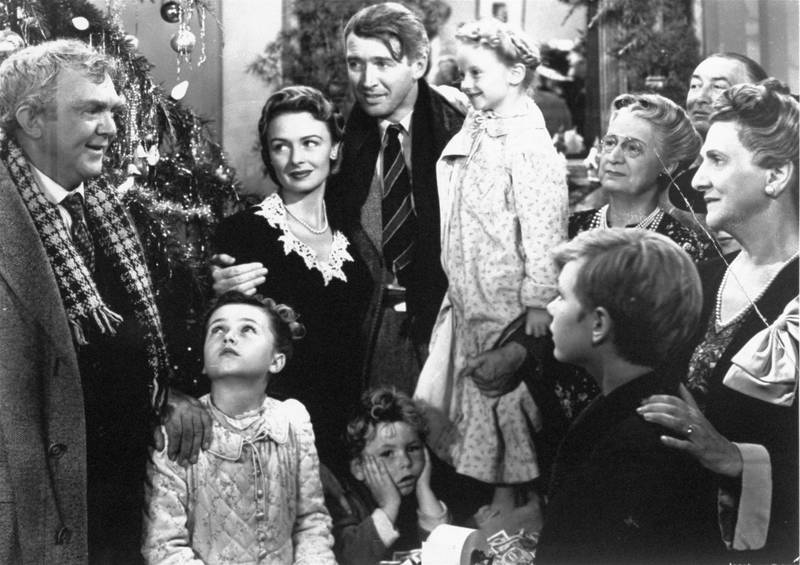 Legendary actor James Stewart as George Bailey (center) is reunited with his wife played by actress Donna Reed (third from left) and family during the last scene of Frank Capra's "It's A Wonderful Life."