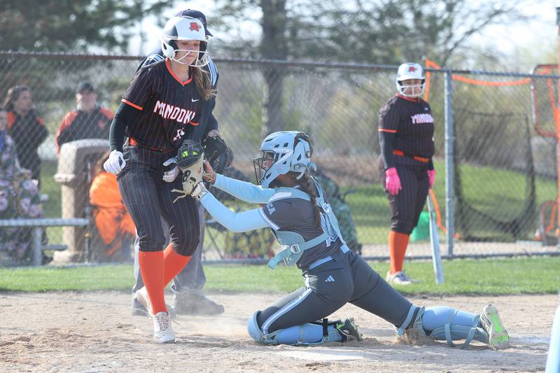 Joliet Catholic’s Emma Mackey tags out  Minooka’s Aubrey Bird on Tuesday, April 7, 2026 in Minooka.