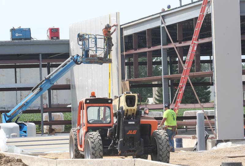 Workers build an exterior wall at the future Aldi grocery store on Tuesday, Aug. 13, 2025 at the intersection of Backbone Road and North Main Street in Princeton. Crews are beginning to build the exterior walls this week. The 20,000 square-foot store could be open by Thanksgiving.