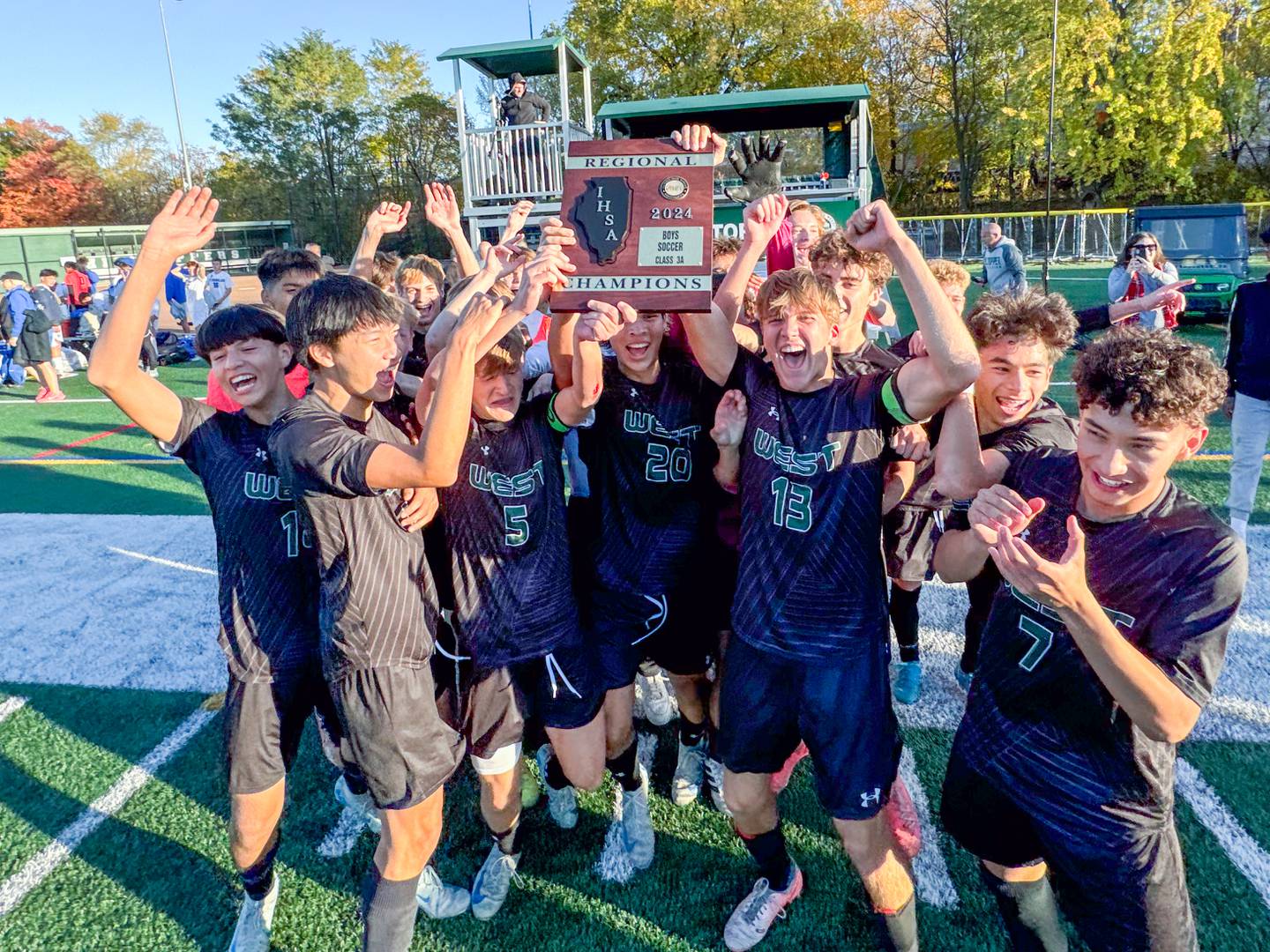 Glenbard West players celebrate their victory over St. Charles North to win the class 3A Glenbard West Regional soccer final at Glenbard West High School in Glen Ellyn on Saturday, Oct. 26, 2024.