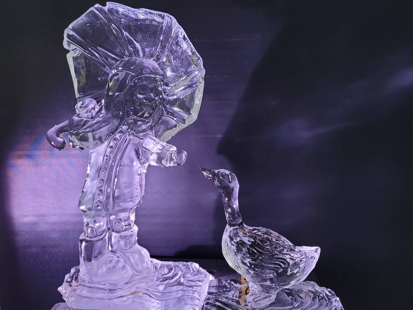 Joliet junior college culinary arts student nalia warmacki's ice sculpture of a girl in a raincoat holding an umbrella and feeding a goose won first place at the fire and ice winter festival in sturgeon bay, wisconsin in mid-february.