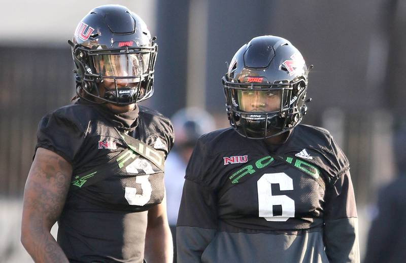 Northern Illinois University defensive backs Devin Lafayette (left) and CJ Brown talk during a break in the action at spring practice Friday, April 7, 2023, in Huskie Stadium at NIU in DeKalb.