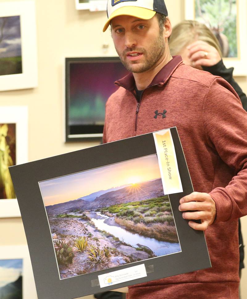 Billy Zborowski holds his 1st place in show photo of Big Bend National Park in Texas during the Starved Rock Photography Show awards on Saturday, Jan. 4, 2024 at the Starved Rock Visitors Center.