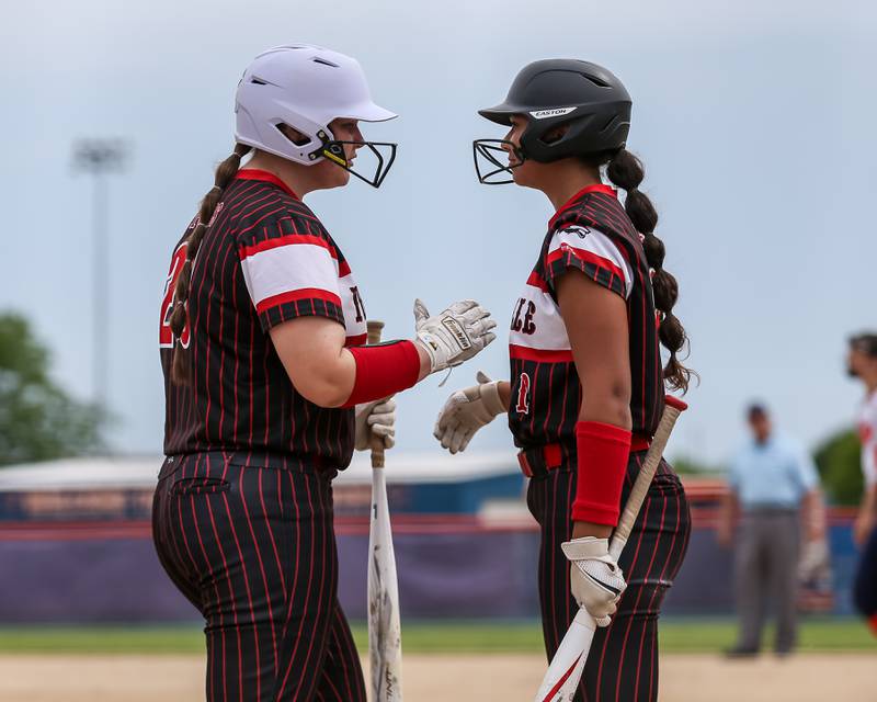 Yorkville's Jensen Krantz (20) is greeted at the plate after scoring a run during Class 4A Oswego Regional final softball game between Yorkville at Oswego. May 24th, 2024.