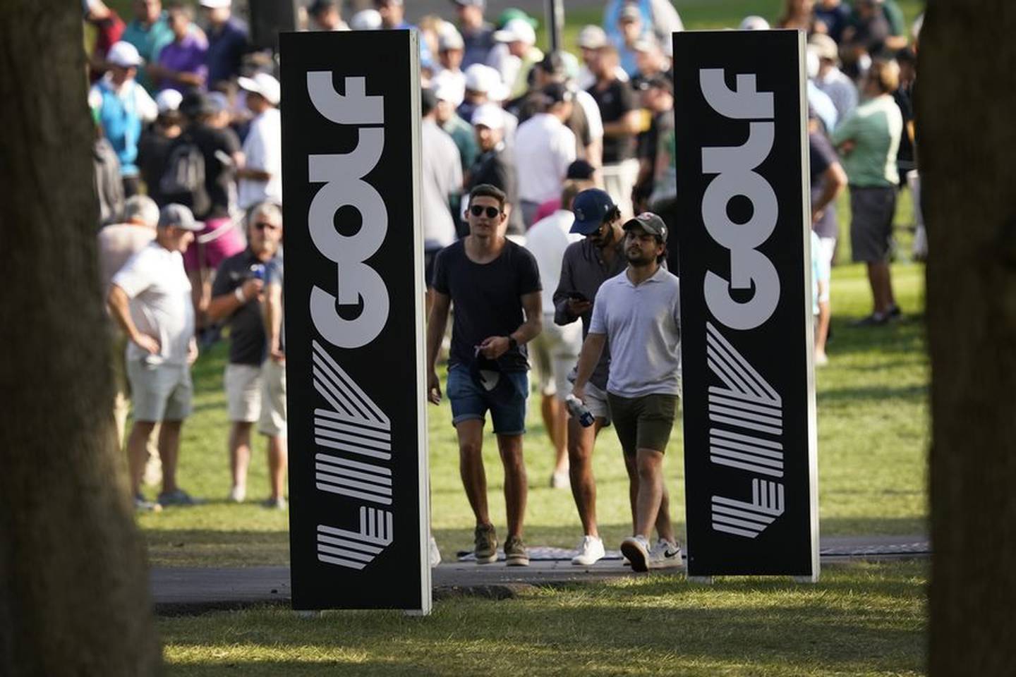 Spectators walk the Rich Harvest Farms golf course during the first round of the LIV Golf Invitational Chicago tournament Friday in Sugar Grove