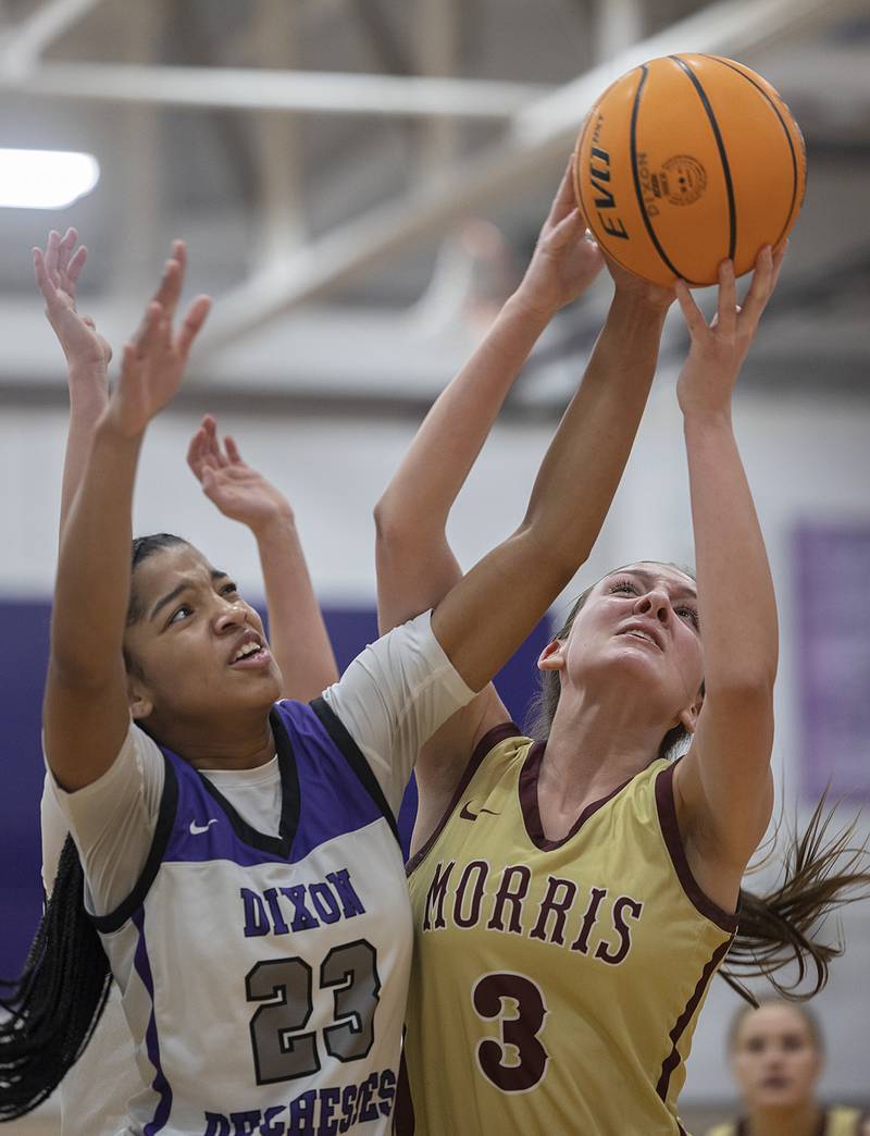 Dixon's Ahmyrie McGowan and Morris’ Lily Hansen battle for a ball Friday, Jan. 3, 2025, at Dixon High School.
