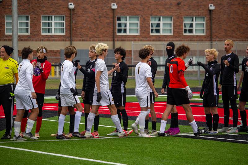 Manteno and Reed-Custer players fist bump ahead of the match before Manteno's 3-0 victory in the Class 1A Momence Regional championship on Saturday, Oct. 25, 2025.