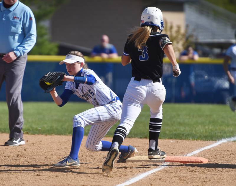 Wheaton North's Ava Hartnett pulls in the ball to get St. Charles North's Leigh VandeHei (3) out at first base during Wednesday’s softball game in Wheaton.