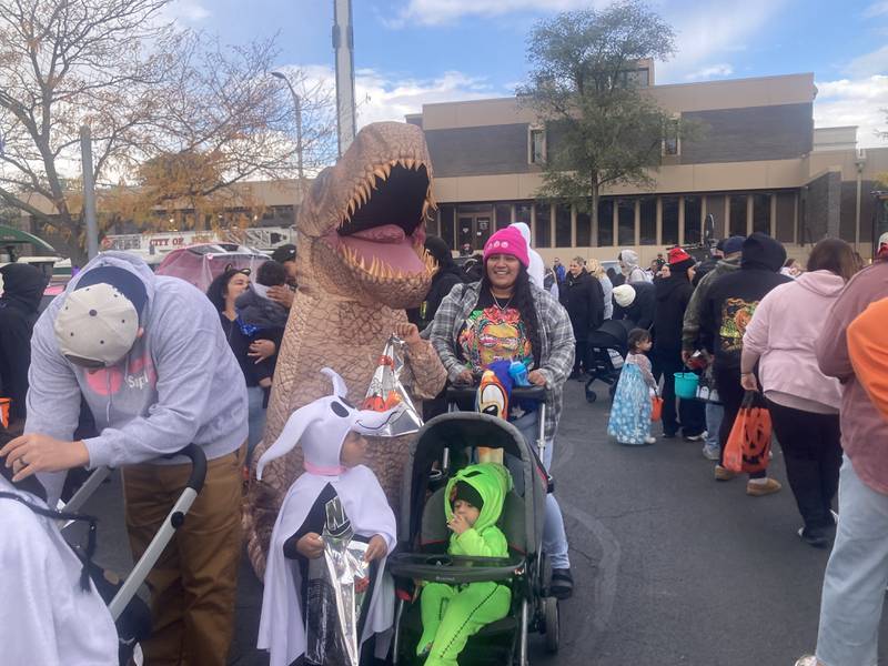 A t-rex trick-or-treats with Zero and Oogie Boogie from A Nightmare Before Christmas at the Joliet Police Department's trunk-or-treat event.
Saturday, Oct. 25, 2025.