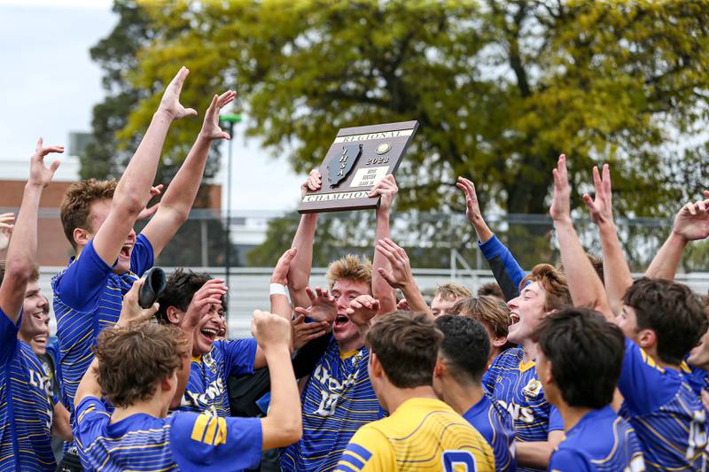 Lyons celebrates with the Class 3A Lyons Regional final plaque after defeating Downers Grove North.  Oct 21, 2023.
