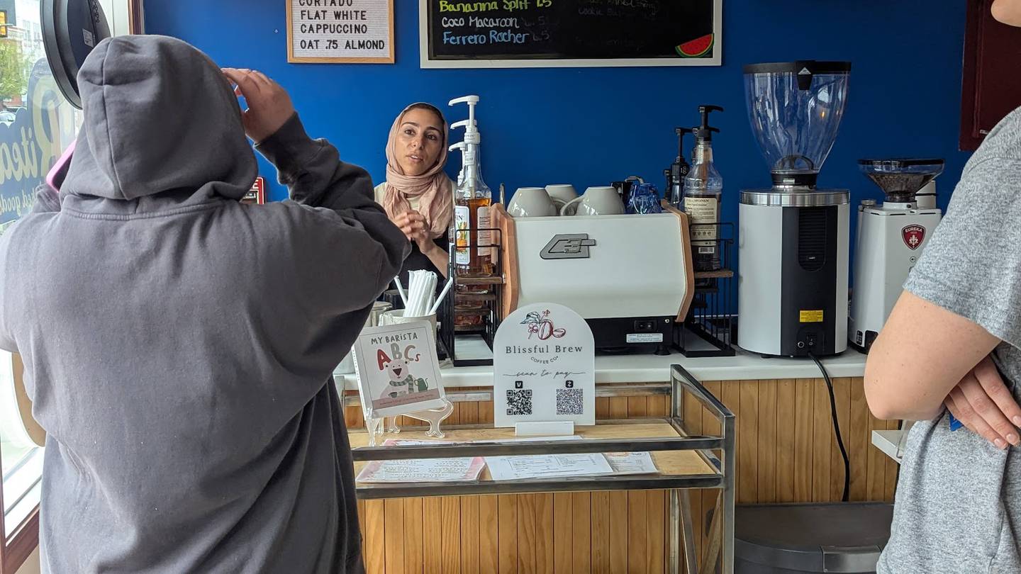 Nour Zein, owner of Blissful Brew Coffee Co. in Lockport, serves customers on Sunday, April 13, 2025.