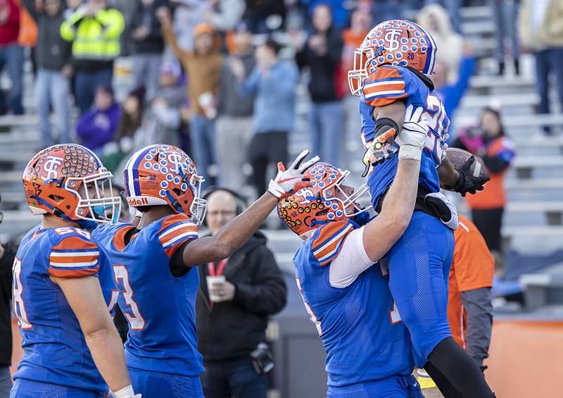 St. Teresa’s Billy Guyse is hoisted after scoring a TD late in the fourth quarter against Tri-Valley in the class 2A IHSA football state championship game Friday, Nov. 25, 2022.
