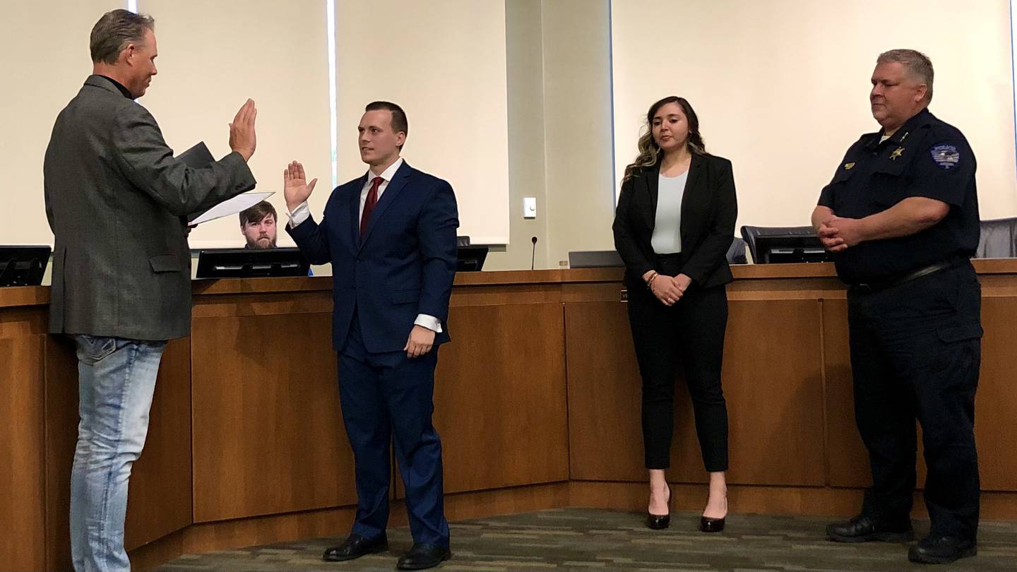 Erika Gutierrez (center right) and Nicholas P. Bozek (center left) were sworn in as Oswego's newest patrol officers by Village President Troy Parlier (left), witnessed by Police Chief Burgner (right) and police commissioner Carrie Niesman (not pictured), at a Village Board meeting April 19.