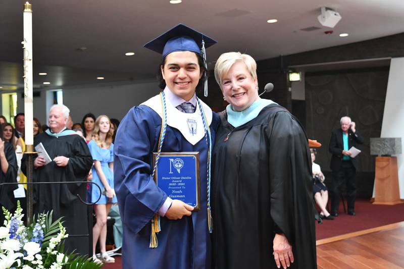 The 2023 Nazareth Academy Sister Oliver Donlin Service Award recipient Noah Guzman of Bolingbrook with Principal Therese Hawkins during the school’s commencement ceremony in La Grange Park on Sunday, May 21, 2023.