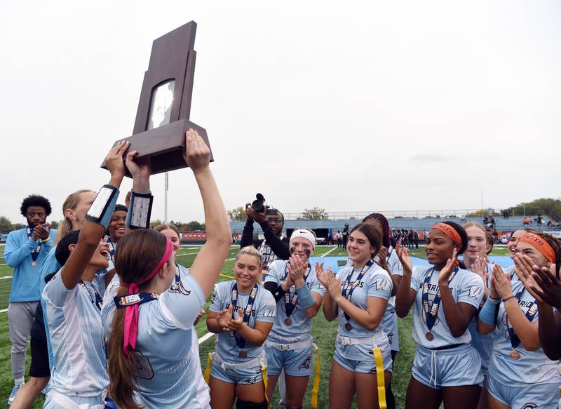 Willowbrook players celebrate with their trophy following their third-place finish with a 30-0 victory over Chicago Perspectives during the flag football state tournament on Saturday, Oct. 18, 2025 in Villa Park.