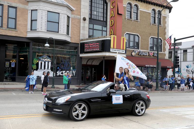 St. Charles North seniors Gianna Hillebrenner and Matthew Colbert ride on the back of a convertible on Friday, Sept. 27, 2024 during the school’s annual homecoming parade in St. Charles.