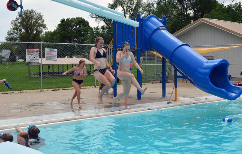 Reagan Grenoble, 15, left, and Leeanne Diaz, 15, leap off the edge of the Polo pool on May 28, with friends Layney Mumford, 15, back left, and Zandra Vock, 12, not visible, close behind. The pool, located at Keator Park, opened on May 27 for the 2022 season.