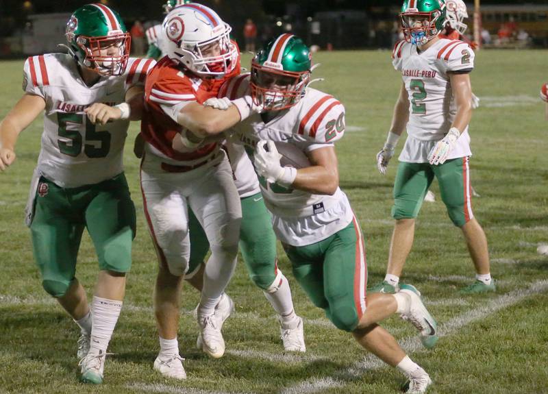 Ottawa's Archer Cechowiz shoves L-P's Griffin May out of bounce on Friday, Sept. 12, 2025 at King Field.