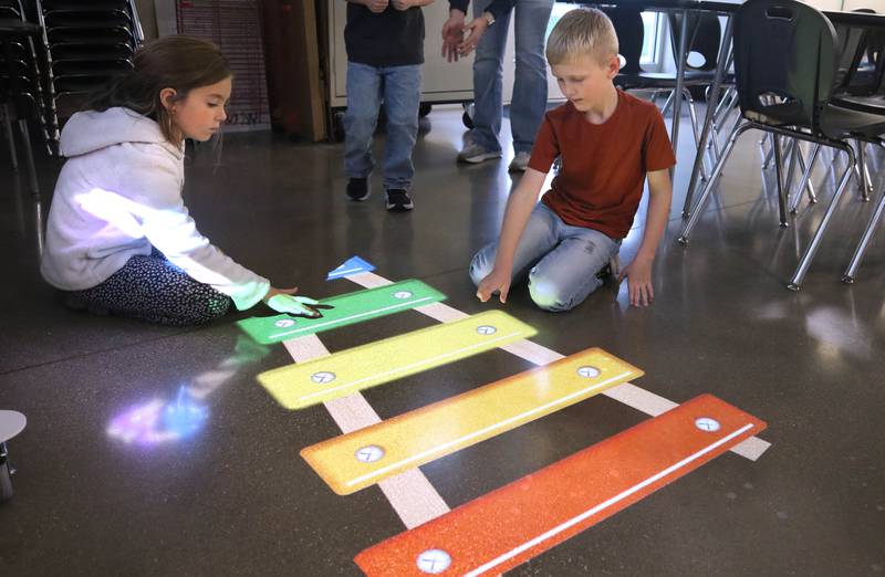 Owen Sanderson, 7, and his cousin Violet Trump, 7, from Kirkland, have some fun with an interactive projected image Wednesday, Nov. 6, 2024, during a grand opening of the Kishwaukee Special Recreation Association’s Sensory Room at the Sycamore Park District Community Center.