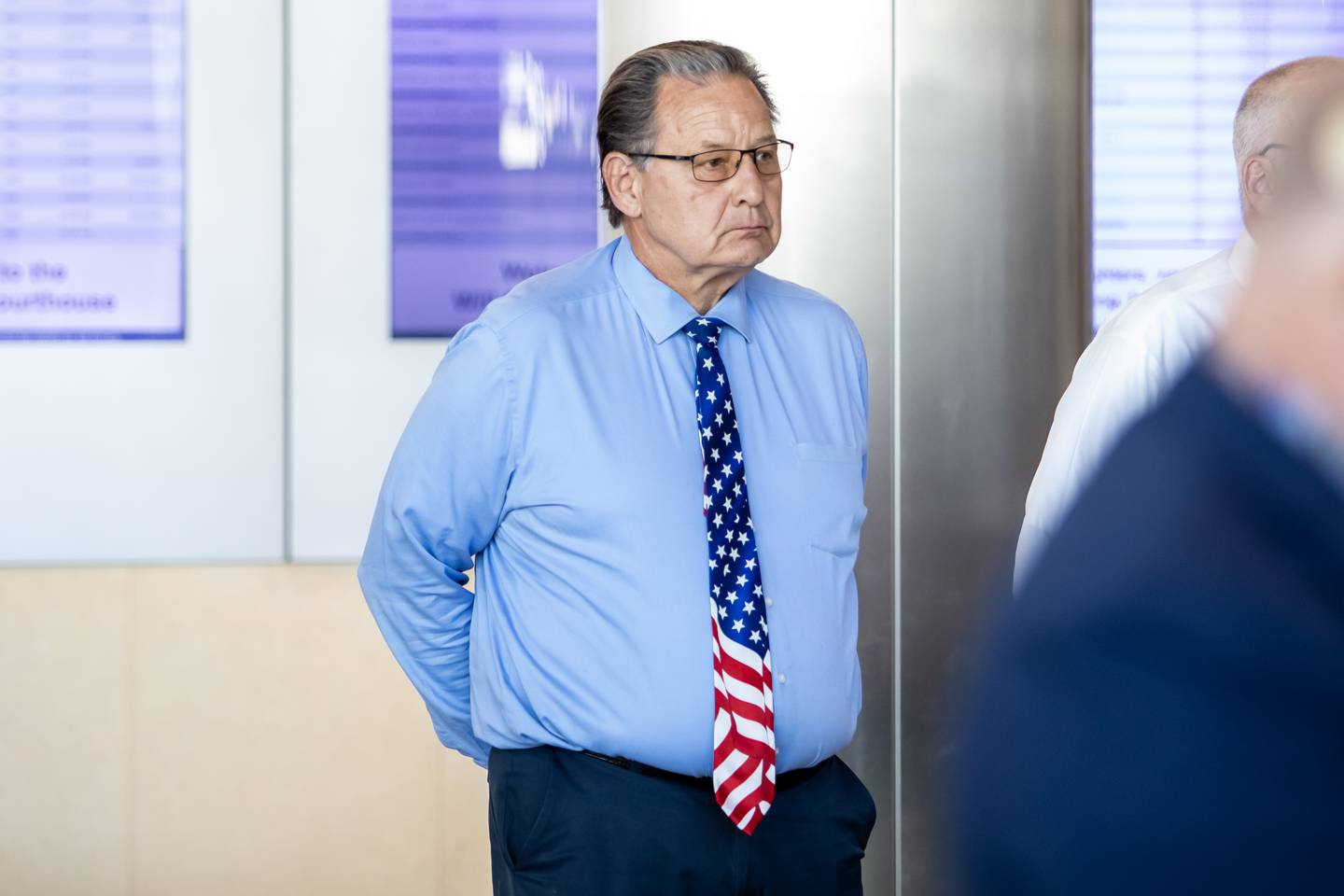 Circuit Court Judge Art Smigielski listens to remarks by Former Governor Pat Quinn during the opening of the ‘Portrait of a Soldier’ exhibit at the Will County Courthouse in Joliet, Illinois on Sept. 11, 2025.
