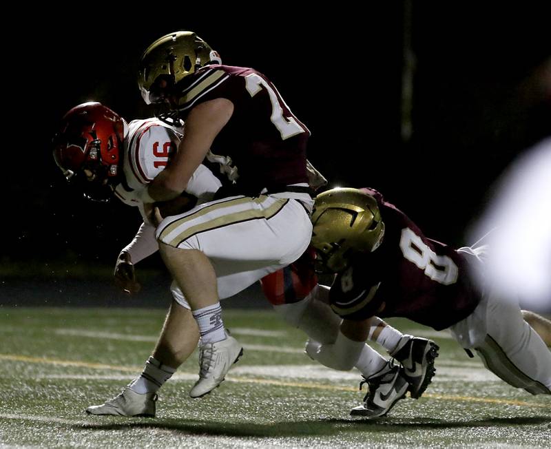 Huntley's Braylon Bower tries to gain some extra yards as he is tackled by St. Ignatius' Declan Boyle and Bo Owen during a IHSA Class 8A second round playoff football game on Friday, Nov. 3, 2023, at St. Ignatius College Prep in Chicago.