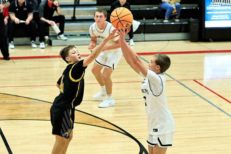 EP's Caleb Brown attempts to get off a 3 point shot above Riverdale's Paxton Kiddoo Friday night during the Turkey Shootout Tournament held in Prophetstown.