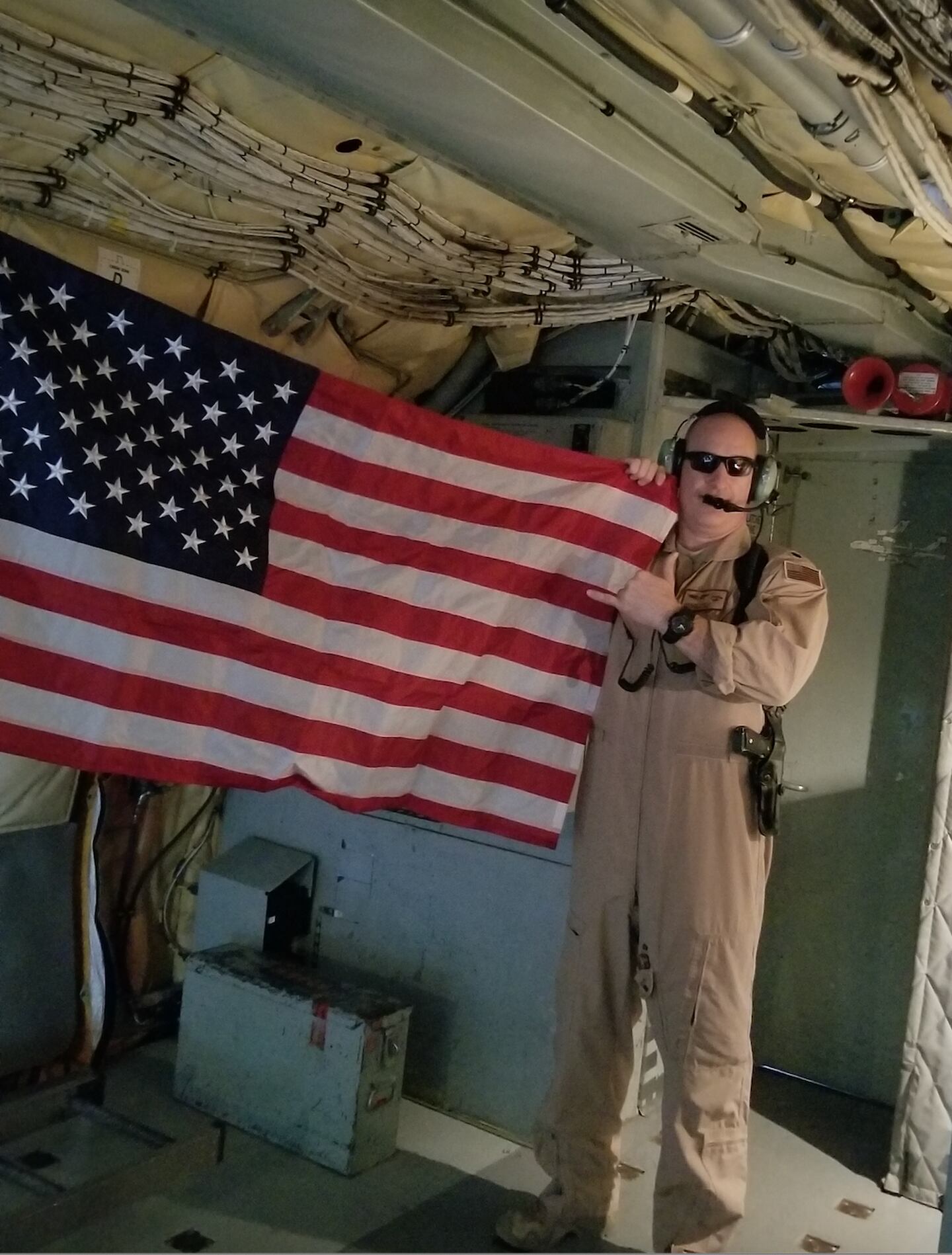 Dr. Gregory Conrad, U.S. National Guard, poses with an American flag during his deployment to Afghanistan in 2019. Conrad also works as an emergency medicine physician at Northwestern Medicine Kishwaukee Hospital in DeKalb.