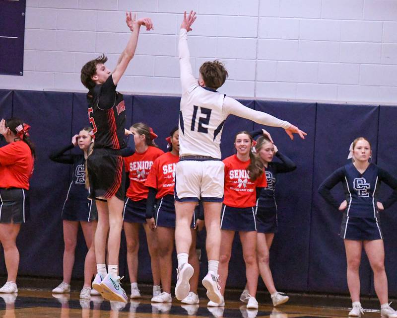 Yorkville's DJ Ingemunson,left, takes a shot while being defended by Oswego East's Lukas Adolfs (12) during the game on Friday Feb. 14, 2025, held at Oswego East High School.