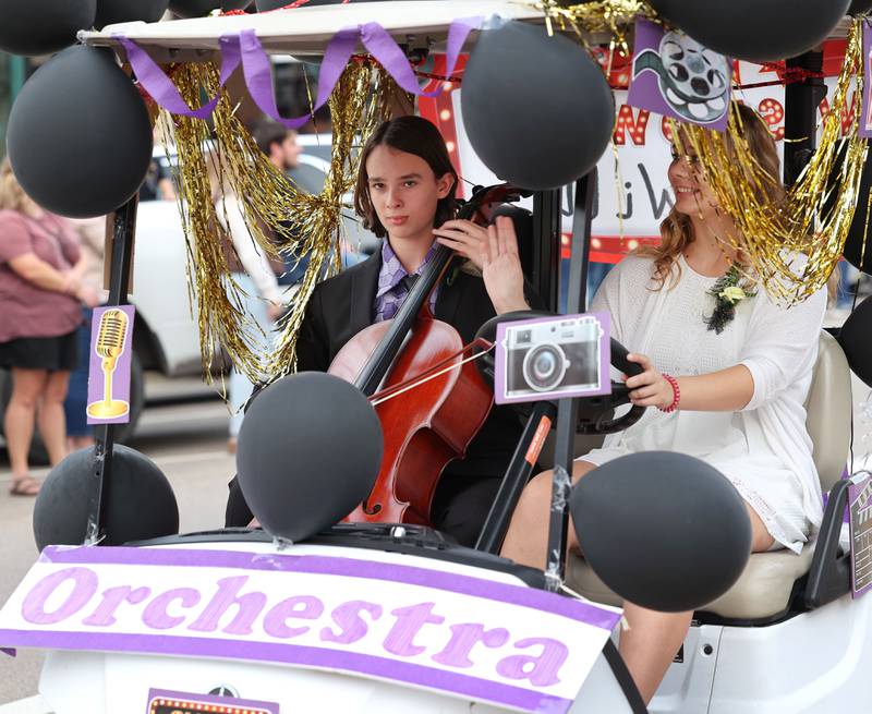 Sycamore High School orchestra golf cart provides music as it heads down State Street Wednesday, Sept. 20, 2023, during the Sycamore High School homecoming parade.