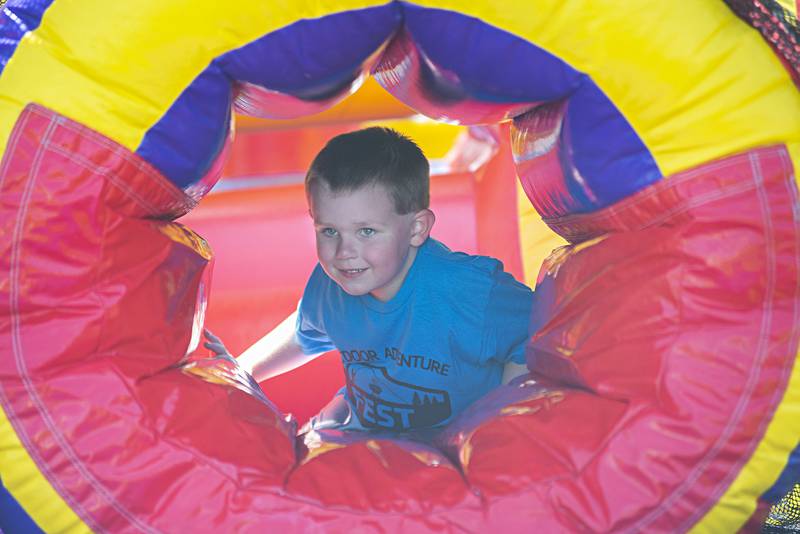 Dennis Miller, 5, of Sterling crawls through one of several inflatables set up Saturday, May 14, 2022 during the Sterling-Rock Falls Family YMCA’s Outdoor Adventure Fest.